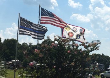 Three flags flying in support of America, Law Enforcement and the U.S. Military.